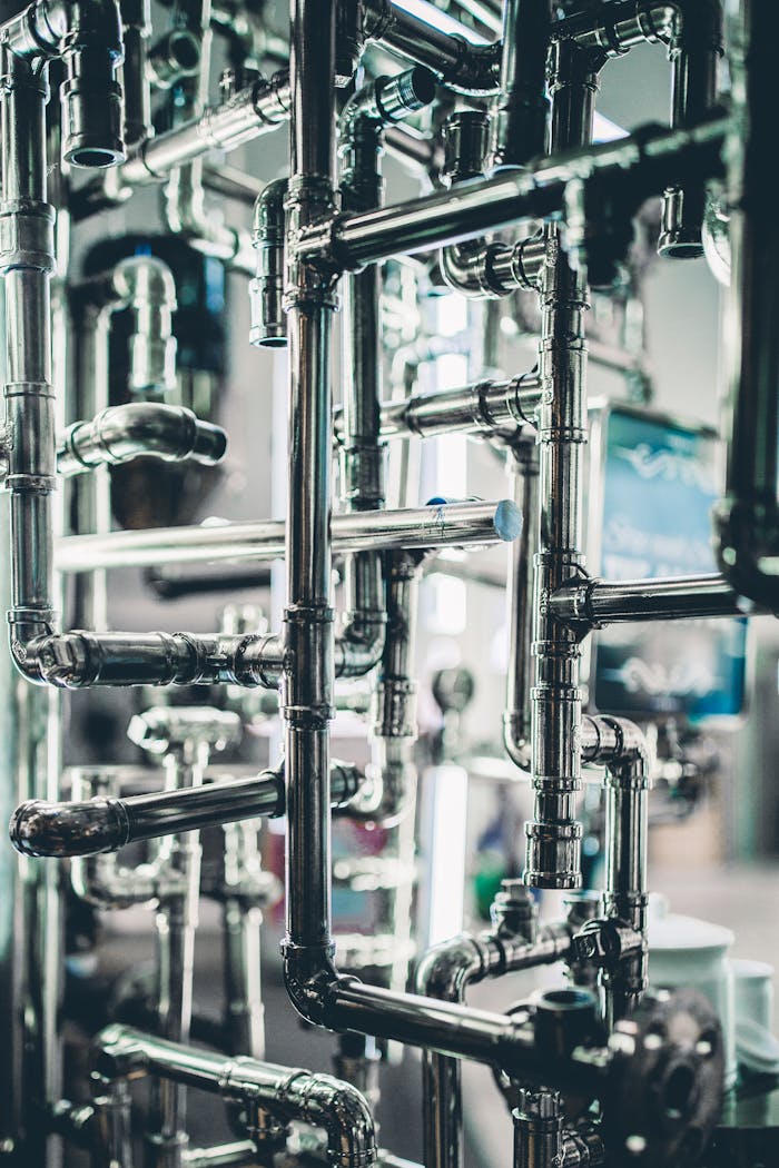 about-us Close-up of complex stainless steel pipes in an industrial setting, showcasing modern engineering.