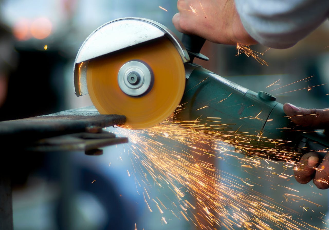 home-hero Angle grinder creating sparks on metal in a workshop.