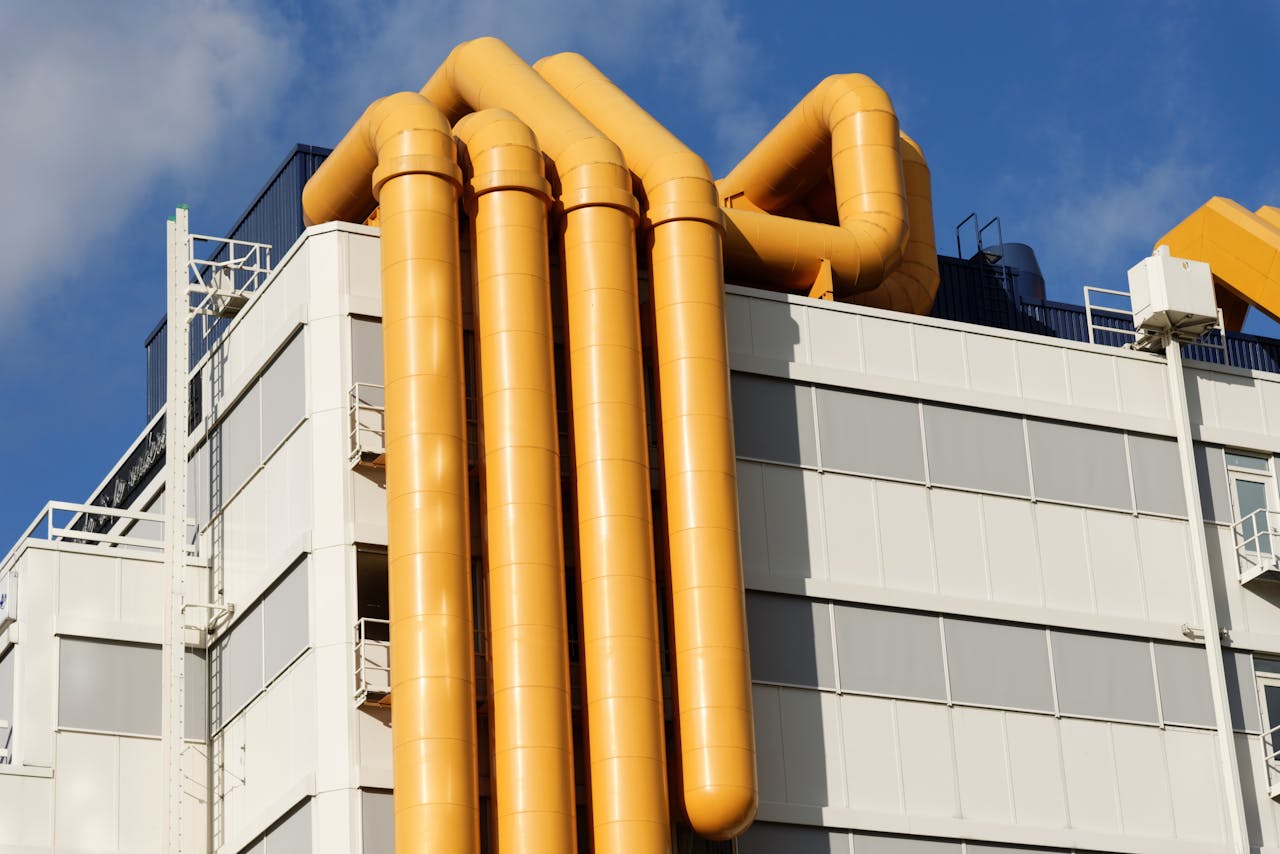 why-choose-us Close-up of a building facade in Rotterdam featuring striking yellow pipes.